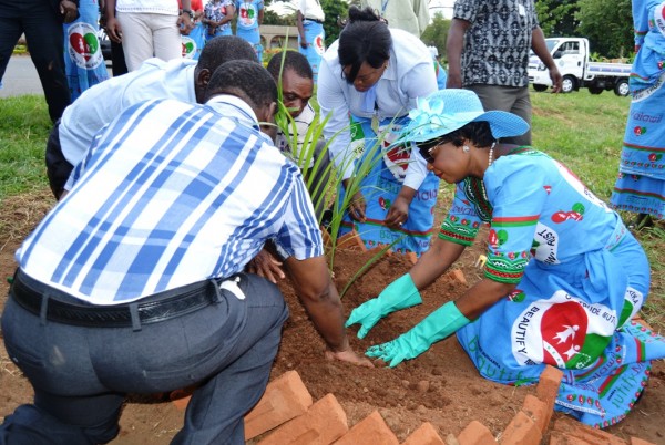First Lady Prof. Gertrude Mutharika planting a tree with community members during a BEAM Trust reforestation event
